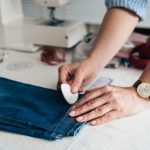Tailor removing extra inches from jeans